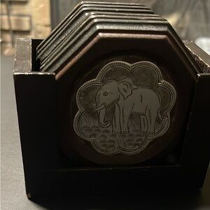 Wooden hexagonal elephant coasters in wood stand